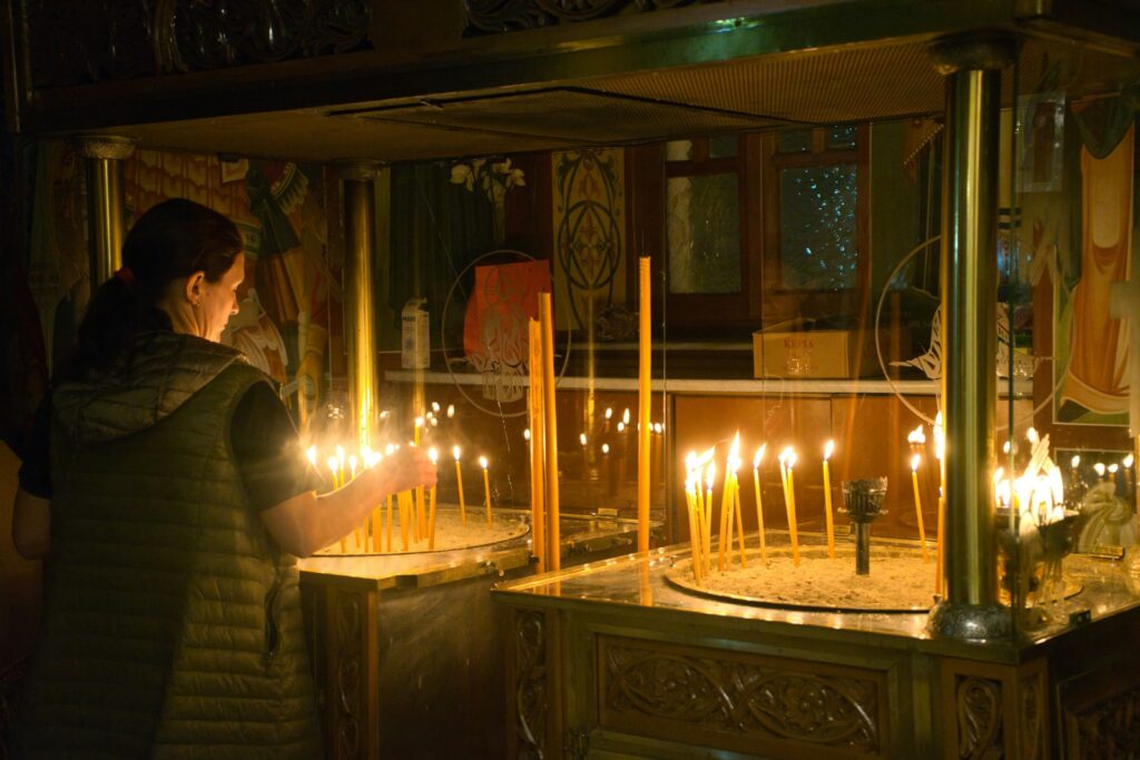 A woman standing in front of a display of candles