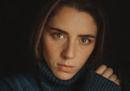 a woman in a blue turtle neck sweater