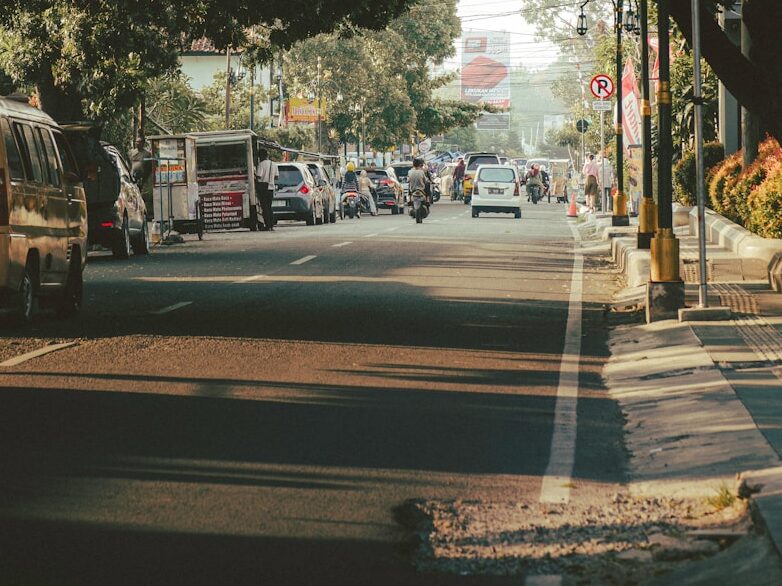 A city street with cars parked on the side of the road