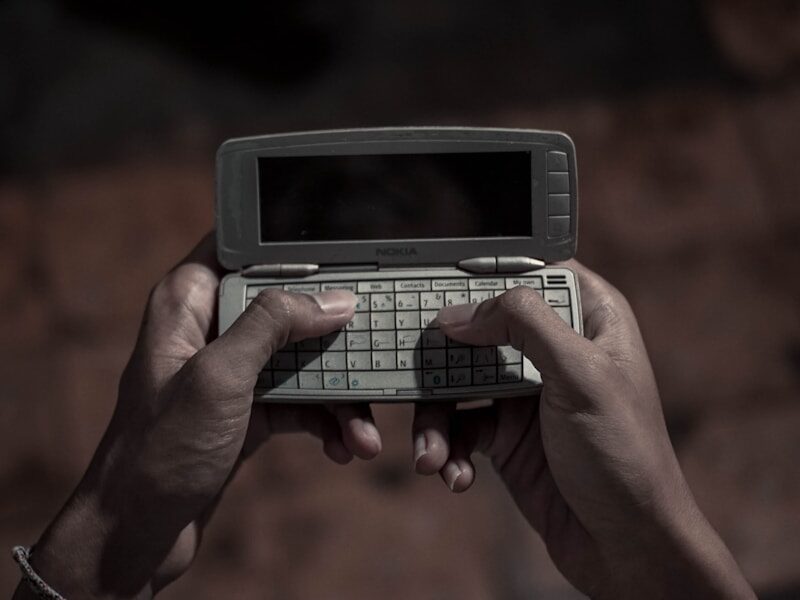 person holding silver electronic diary