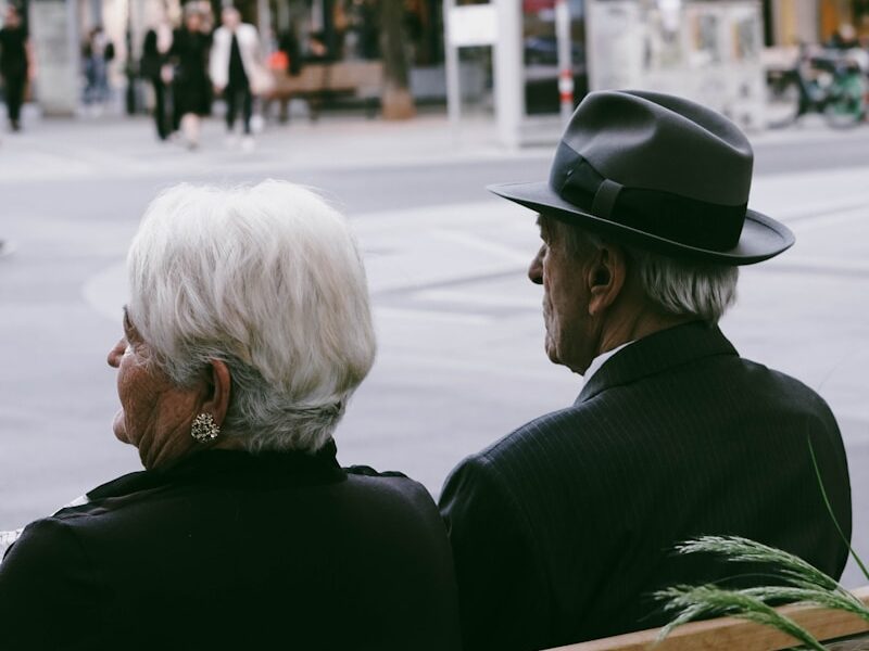 a couple of men sitting on a bench