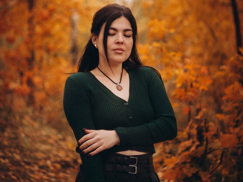 Woman standing in a forest during autumn
