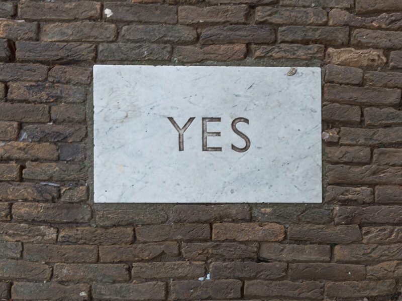 white and black i love you print on brick wall