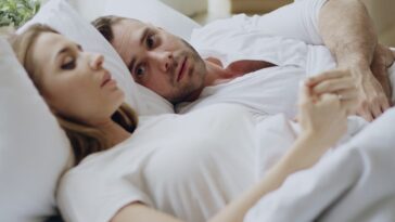 Couple lying in bed together