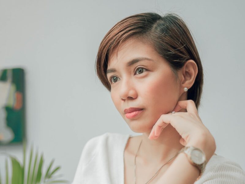 woman in white button up shirt sitting on chair