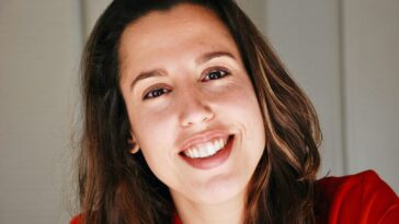 woman in red shirt smiling