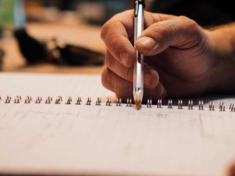 a hand holding a pen