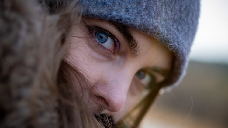 a close up of a person wearing a hat