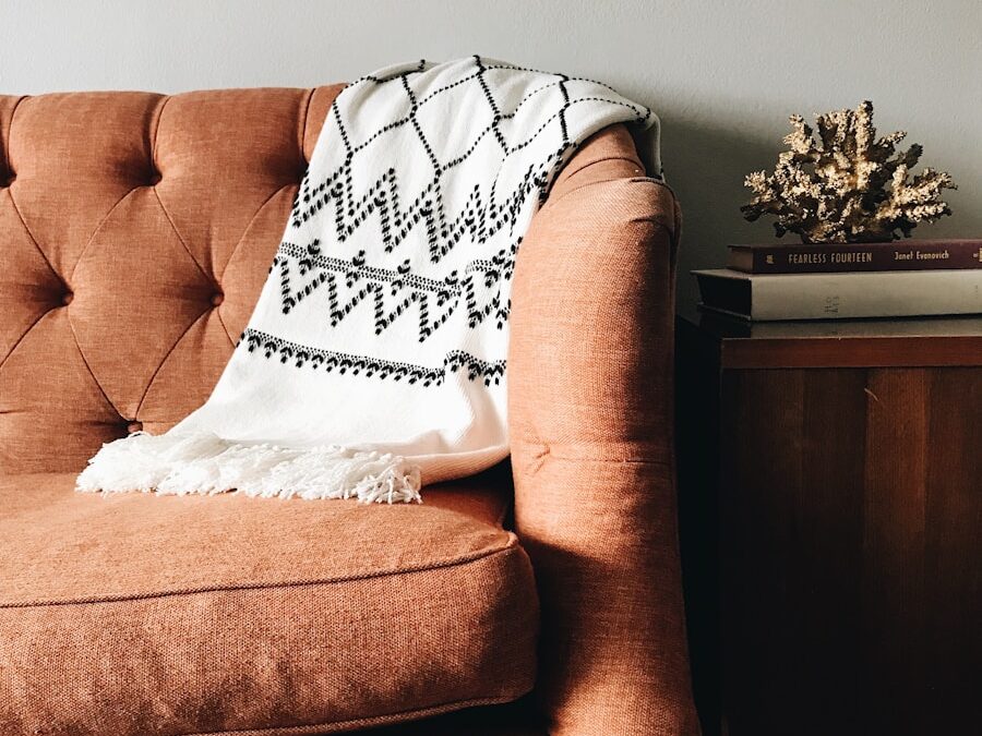 white and black textile on brown couch