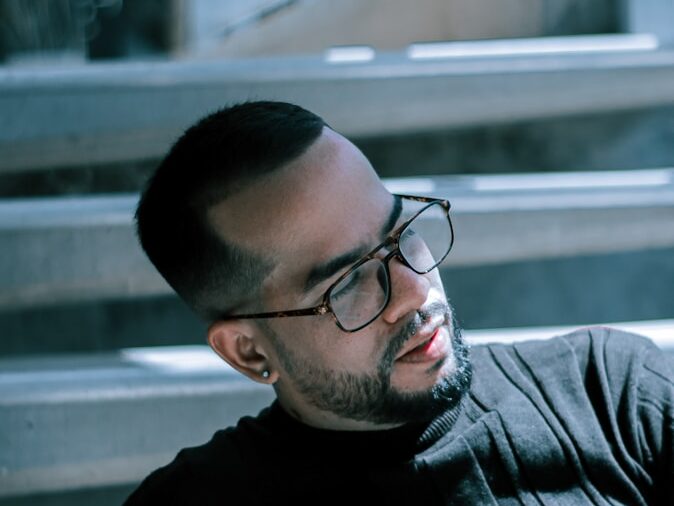 man in black crew neck shirt wearing black framed eyeglasses