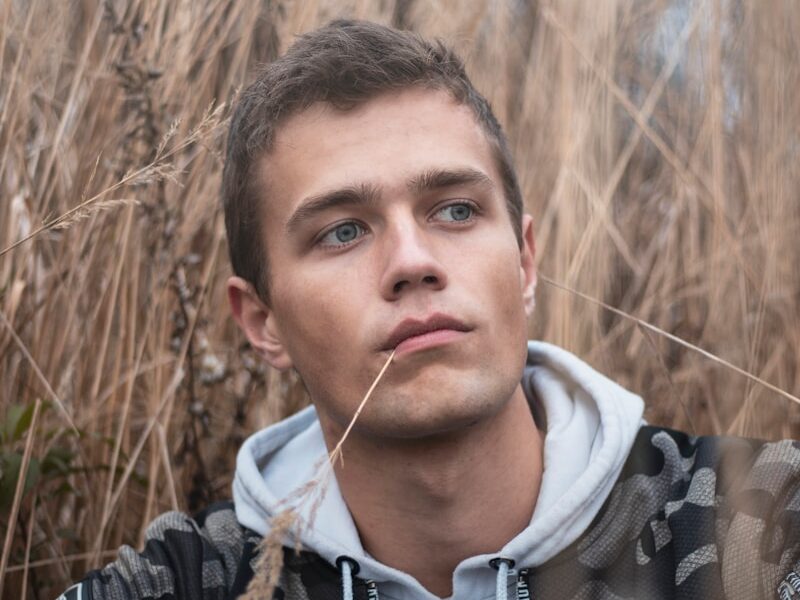 man surrounded by grass