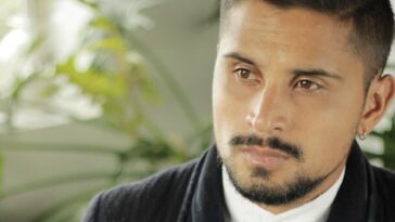 man holding brown mug