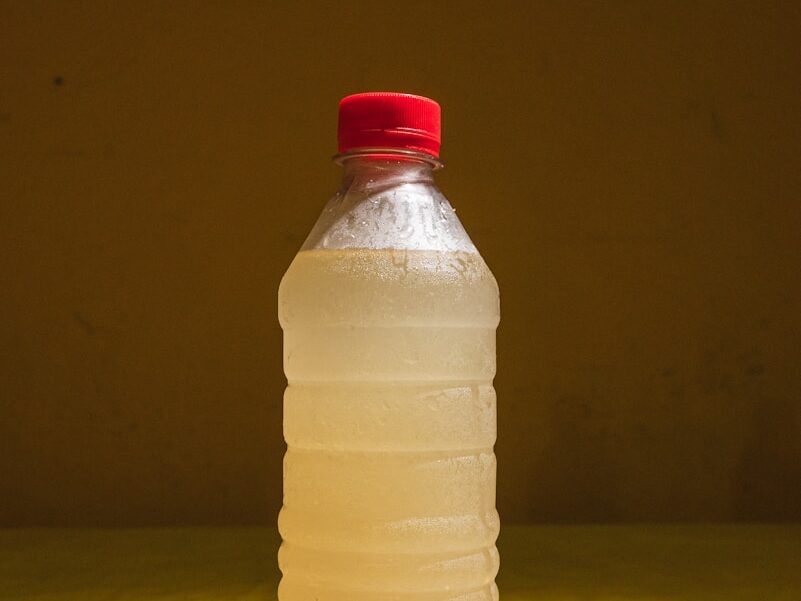 A bottle of water sitting on top of a checkered table