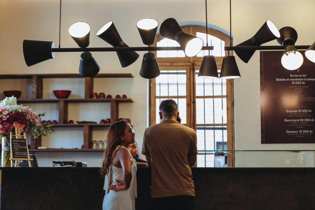 Couple at a reception desk with modern lighting.