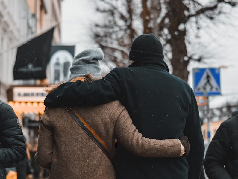 a couple of people walking down a street