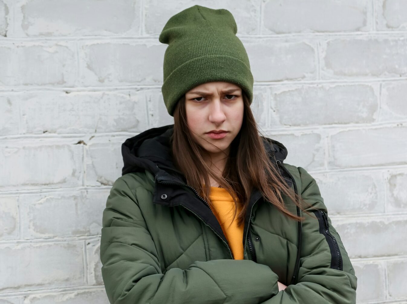 woman in green knit cap and green jacket