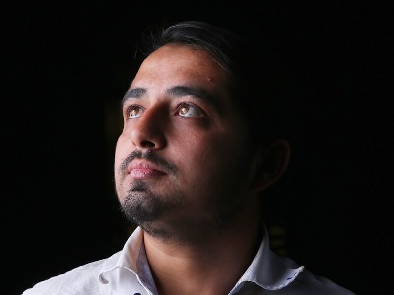 a man in a white shirt looking up