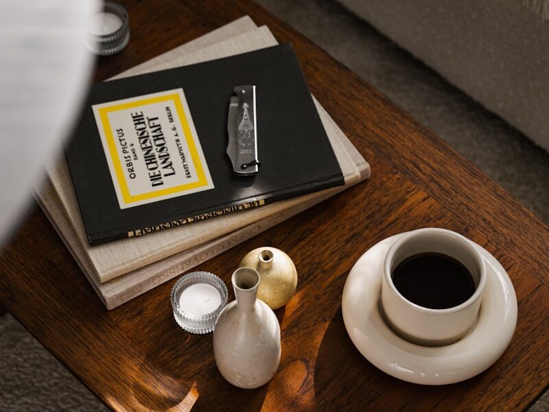a coffee table with a book and a vase on it