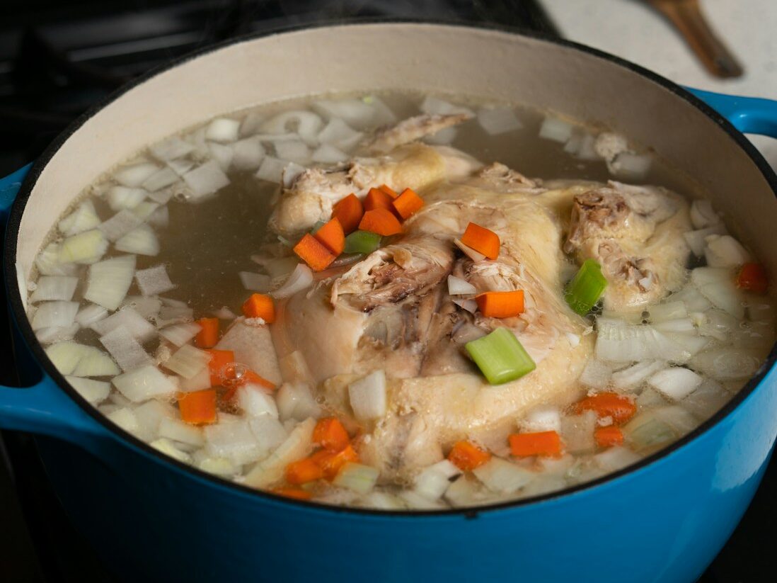 white rice with green peas and carrots in blue ceramic bowl