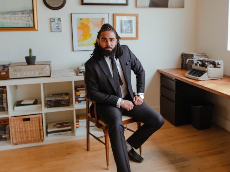 man in black jacket sitting on chair