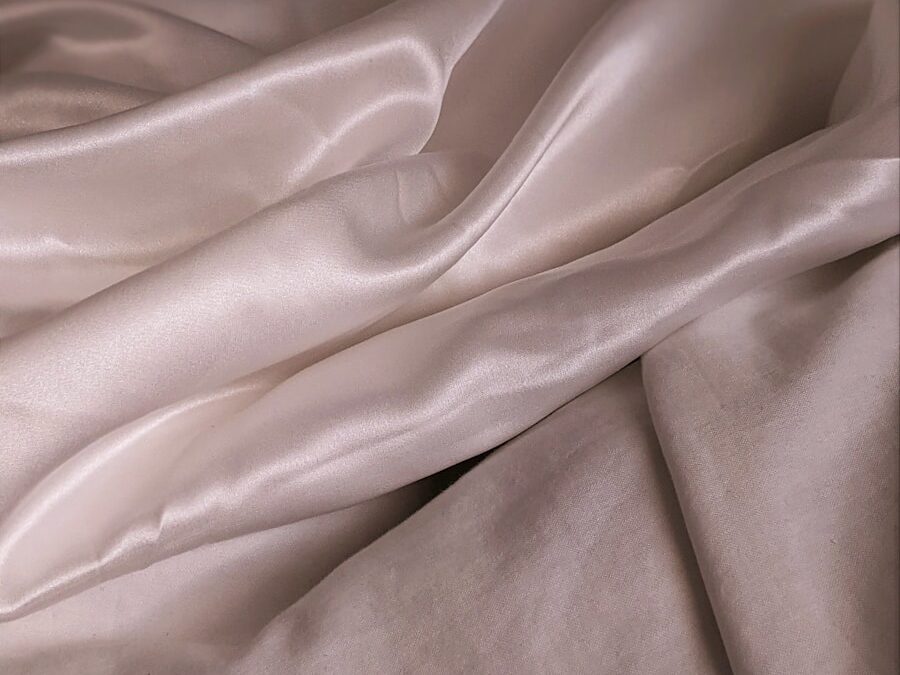 white textile on brown wooden table