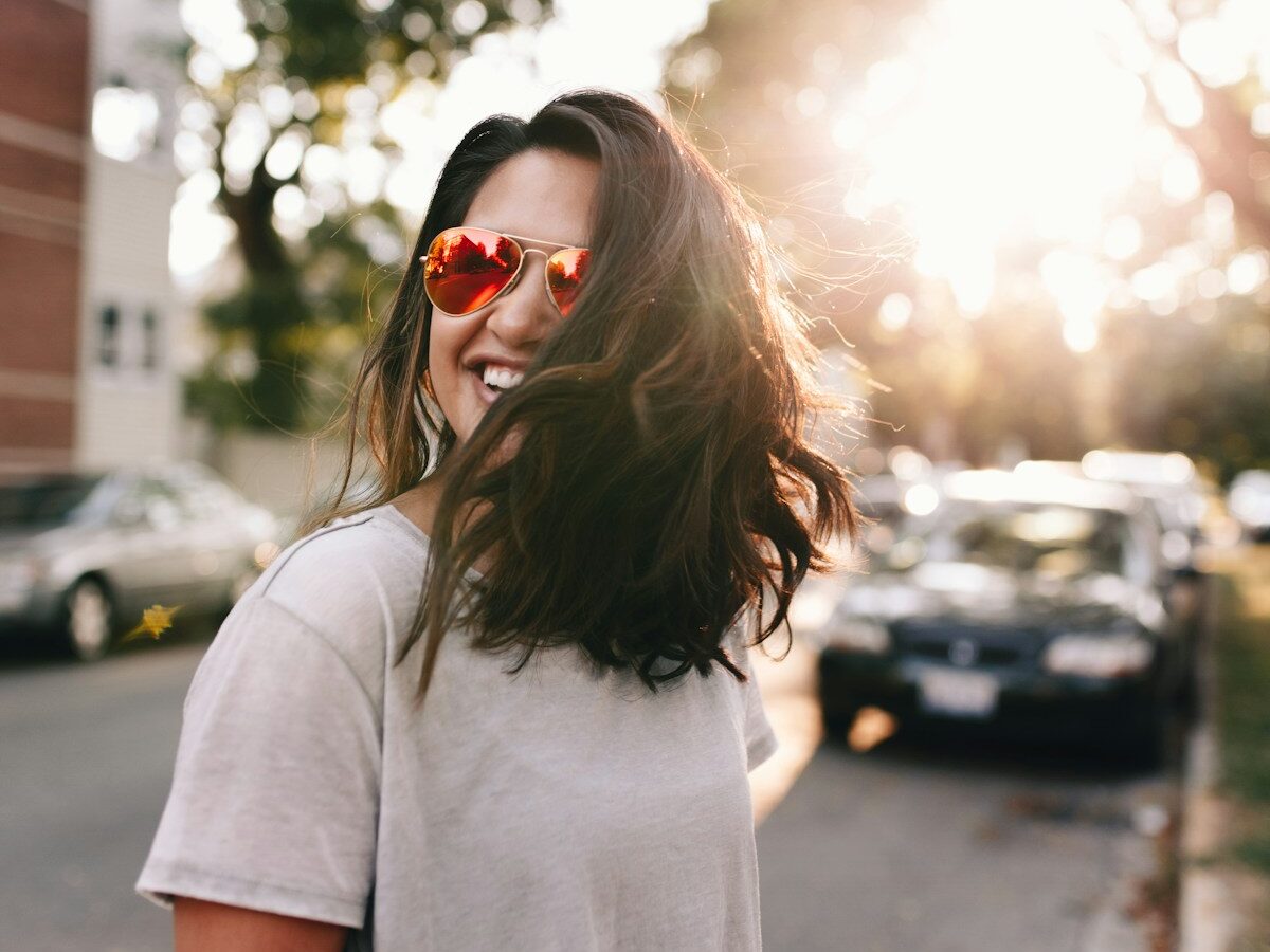 woman wearing white T-shirt smiling