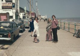 a group of people standing on the side of a road