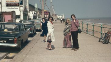 a group of people standing on the side of a road