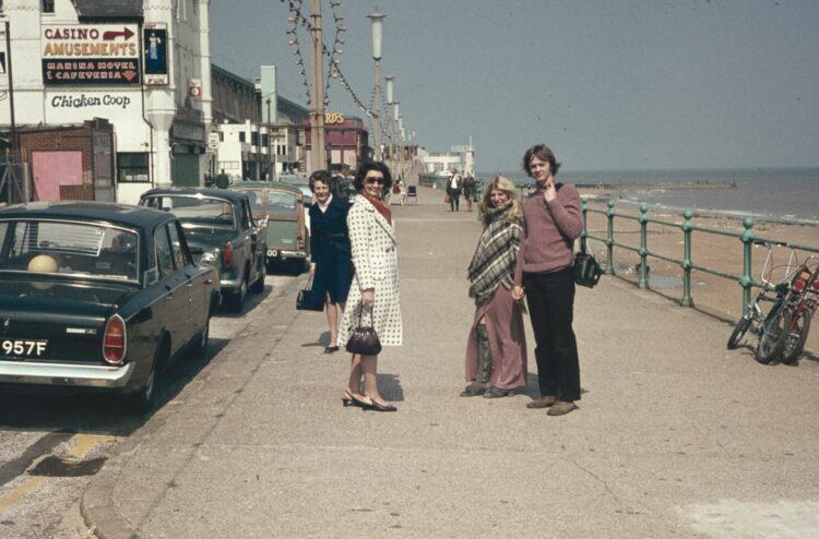 a group of people standing on the side of a road