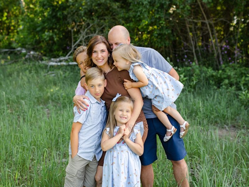 a family poses for a picture in a field