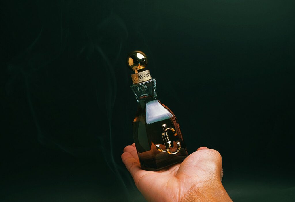 A person holding a bottle of alcohol in their hand