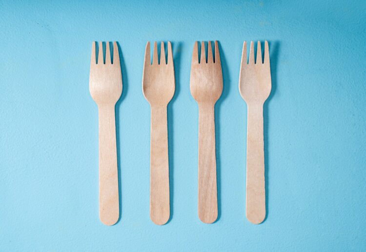 A set of four forks and a knife on a blue background