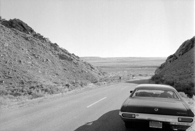 grayscale photo of car on road