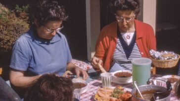 women sitting beside table