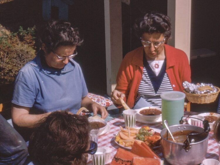 women sitting beside table