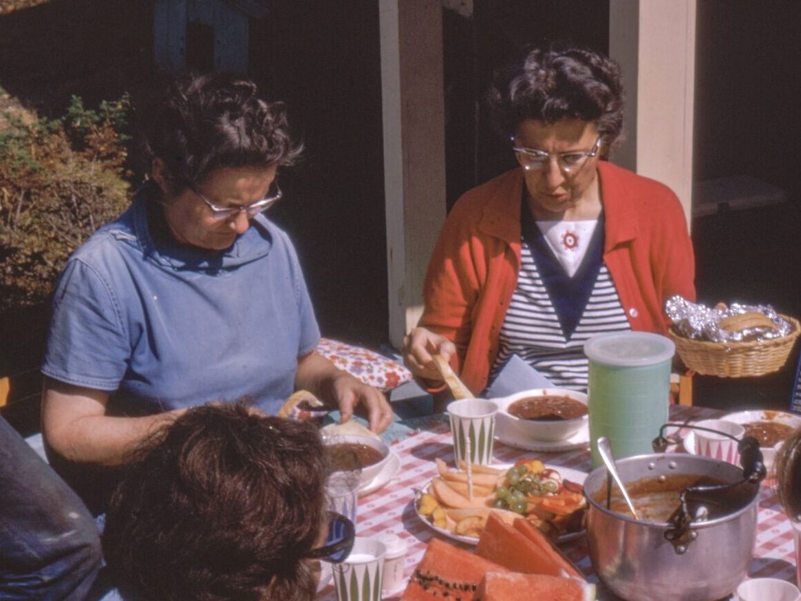 women sitting beside table