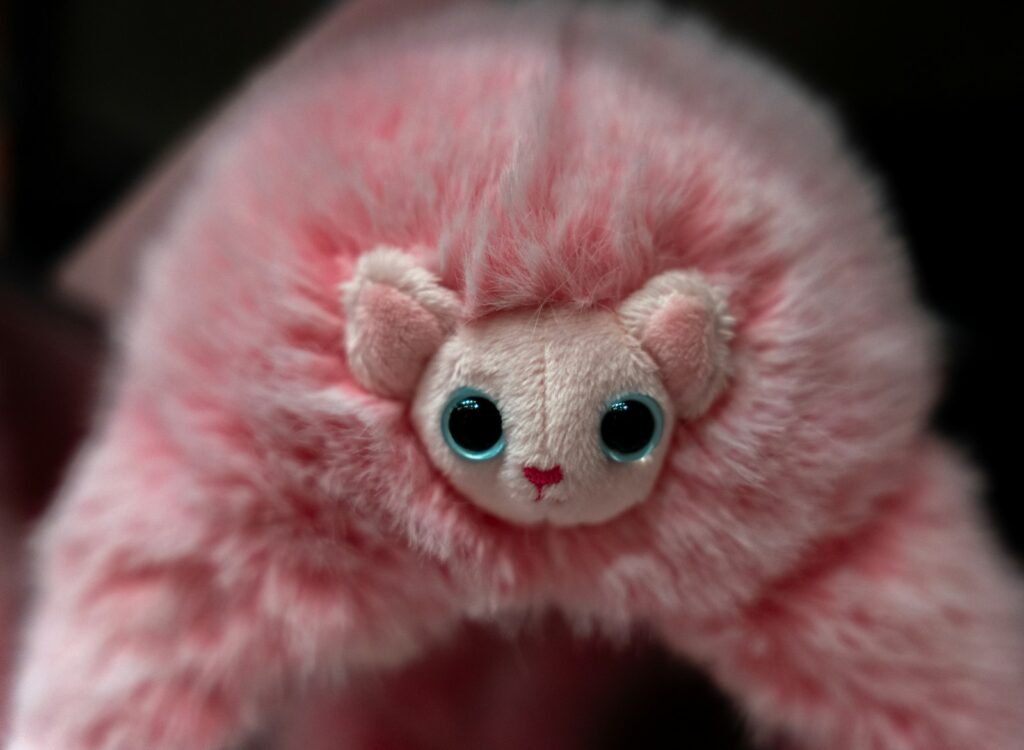 A pink niffler toy stares intently at the camera.