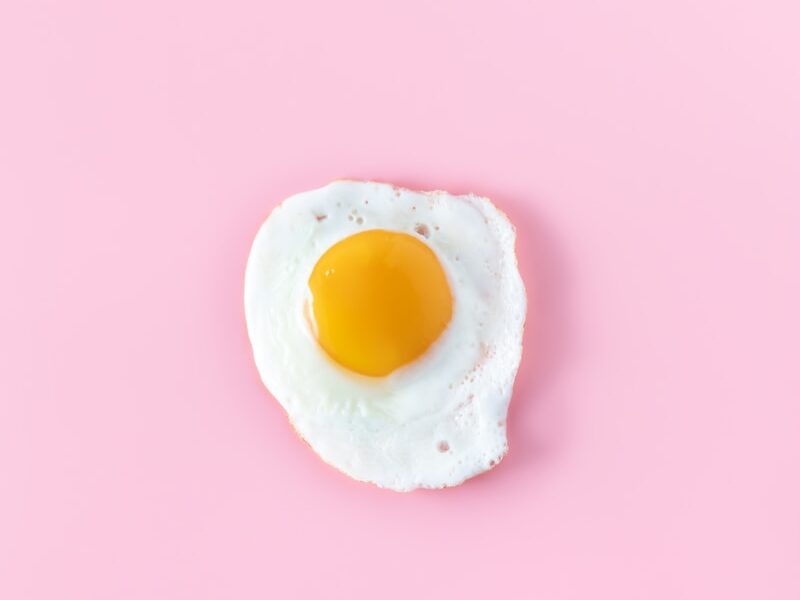 sunny side up egg on pink surface
