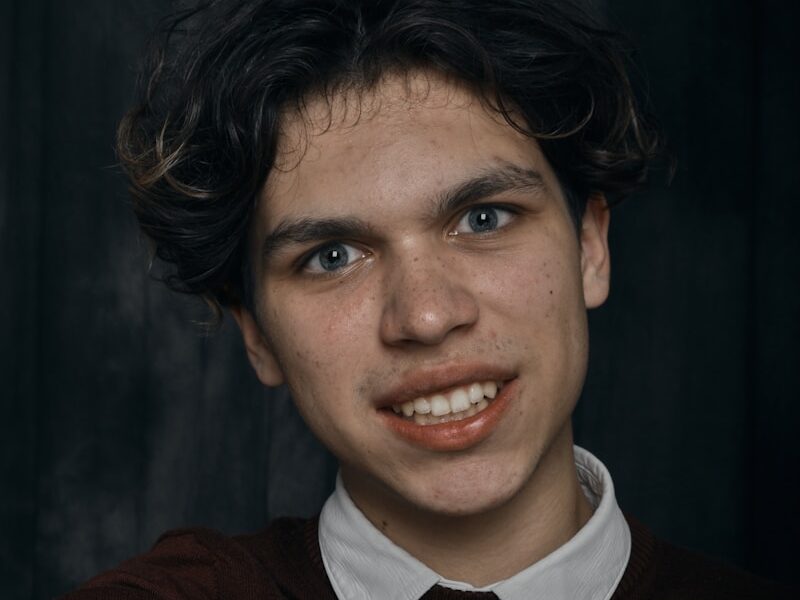 a young man making a hand gesture with his fingers