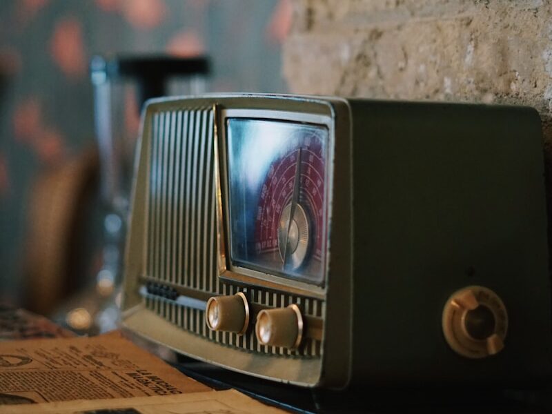 black and silver radio on brown wooden table