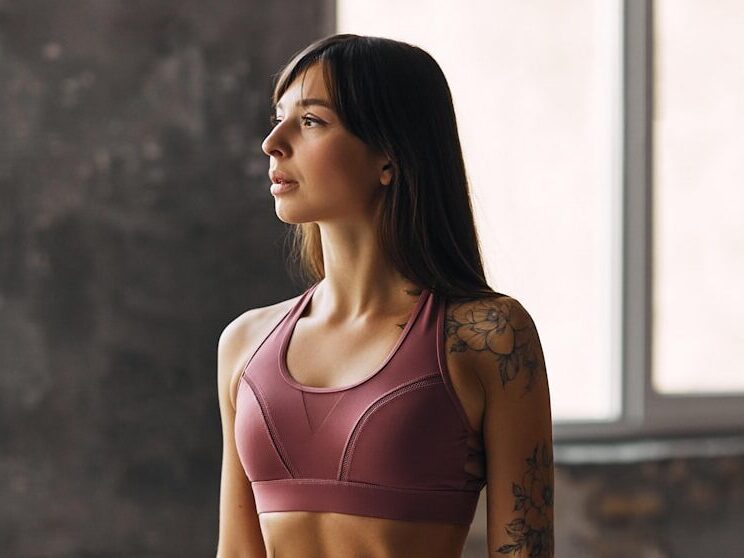 woman in pink sports bra and pink leggings