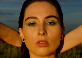 man wearing black spaghetti strap top