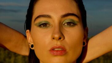 man wearing black spaghetti strap top