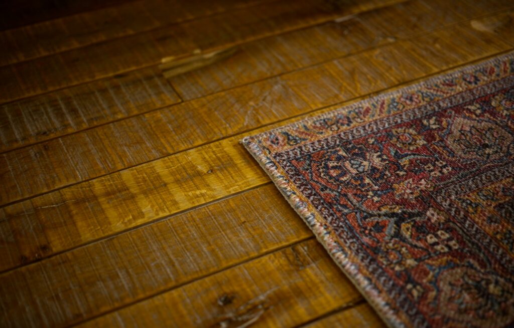 a close up of a rug on a wooden floor