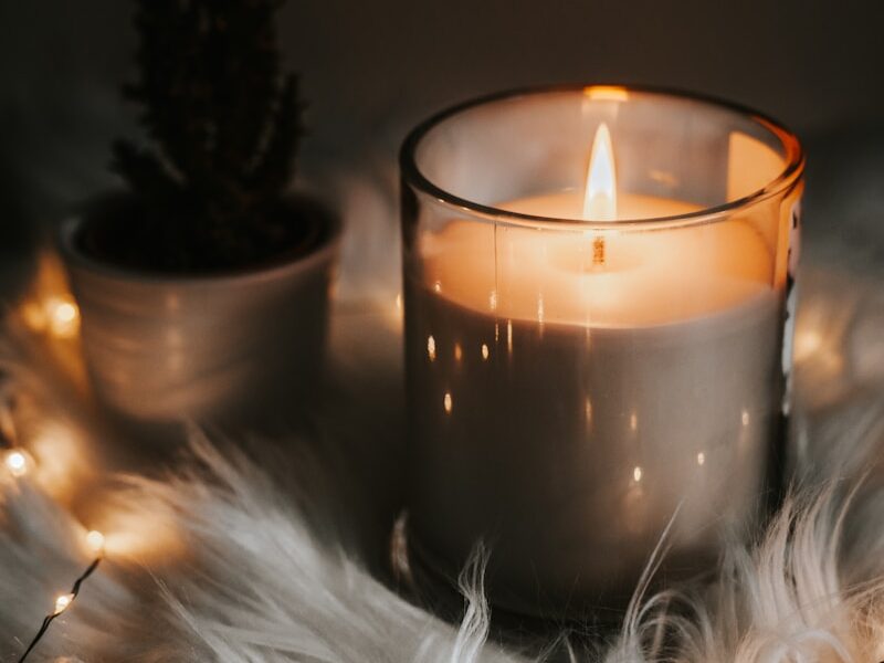 lighted candle in the dark