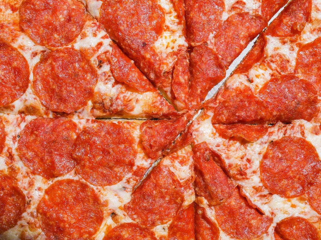 Close-up of a cheesy pepperoni pizza with mouth-watering toppings.