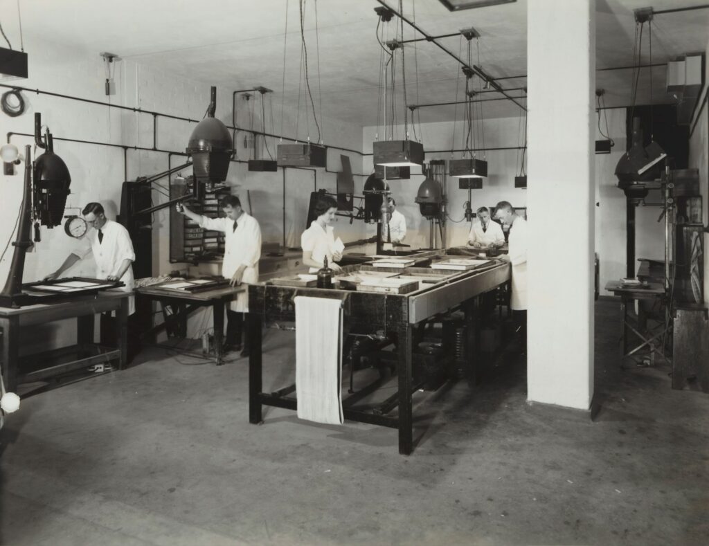 three persons standing beside table