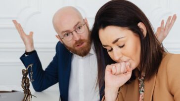 Upset couple arguing indoors, emotional tension and conflict in a legal setting.