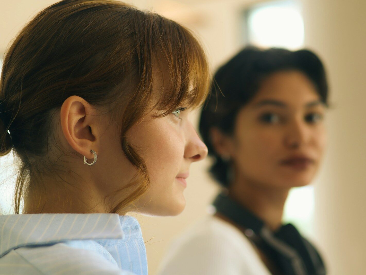Two women looking in different directions