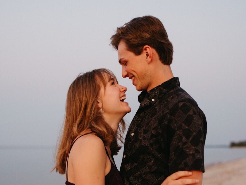 man and woman kissing each other during daytime